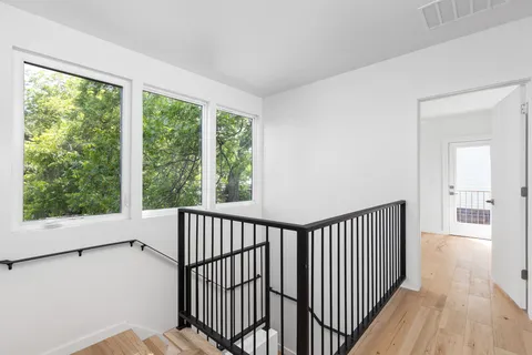 a view of a room with wooden floor and windows