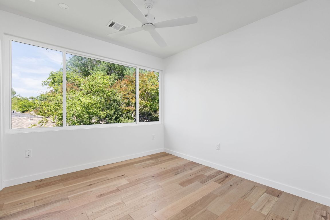 2903 Breeze Terrace, Unit 2 Austin, TX 78722 - Photo 22 of 36 Empty room featuring baseboards, light wood-style flooring, and ceiling fan