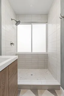 a bathroom with a shower and a sink