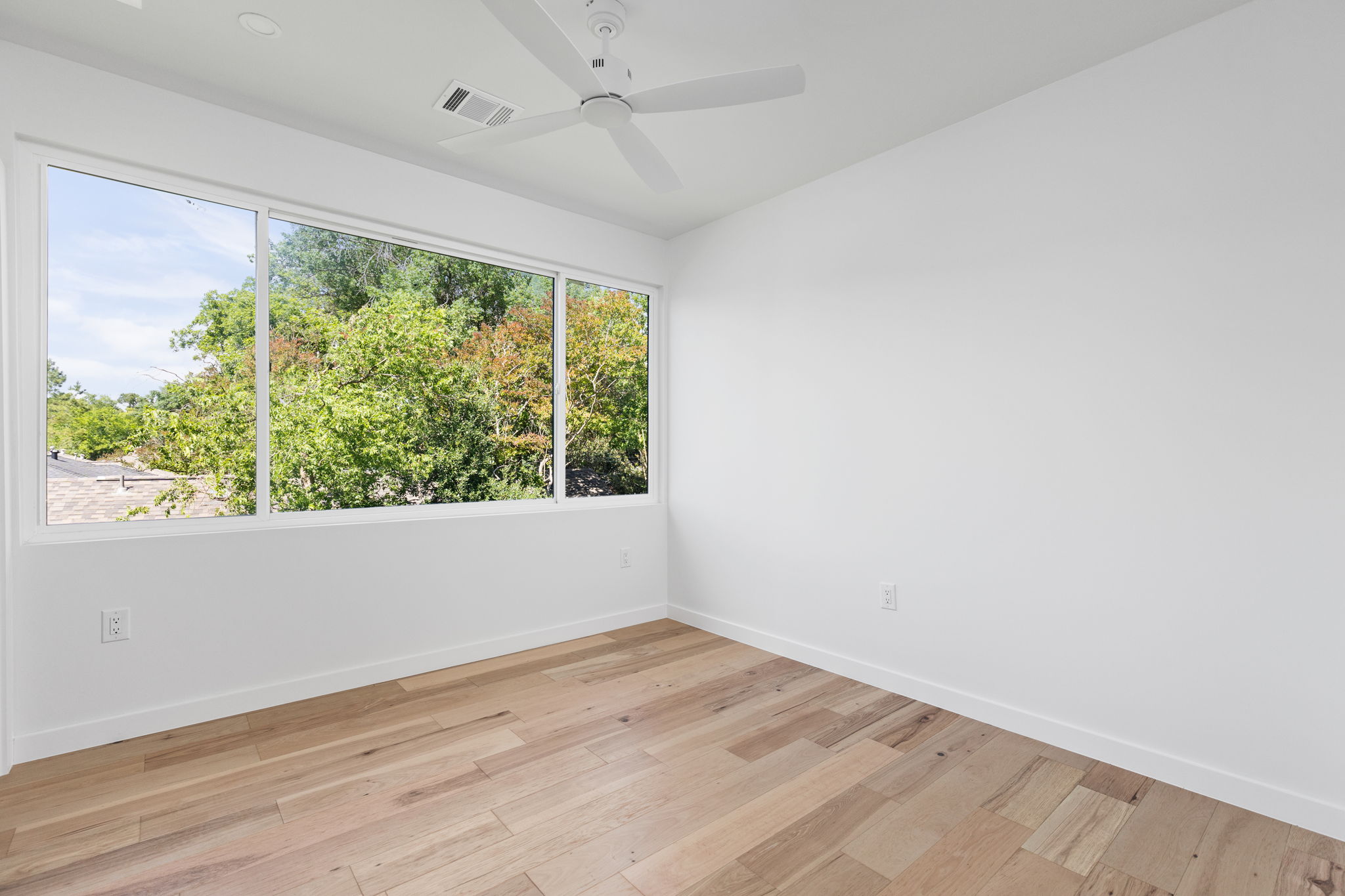 2903 Breeze Terrace, Unit 2 Austin, TX 78722 - Photo 24 of 36 Empty room featuring baseboards, light wood-style flooring, and ceiling fan