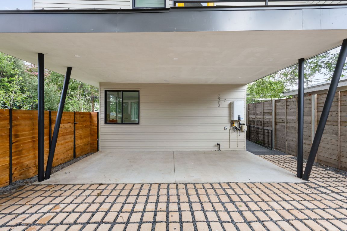 2903 Breeze Terrace, Unit 2 Austin, TX 78722 - Photo 4 of 36 View of patio with a carport and tankless water heater