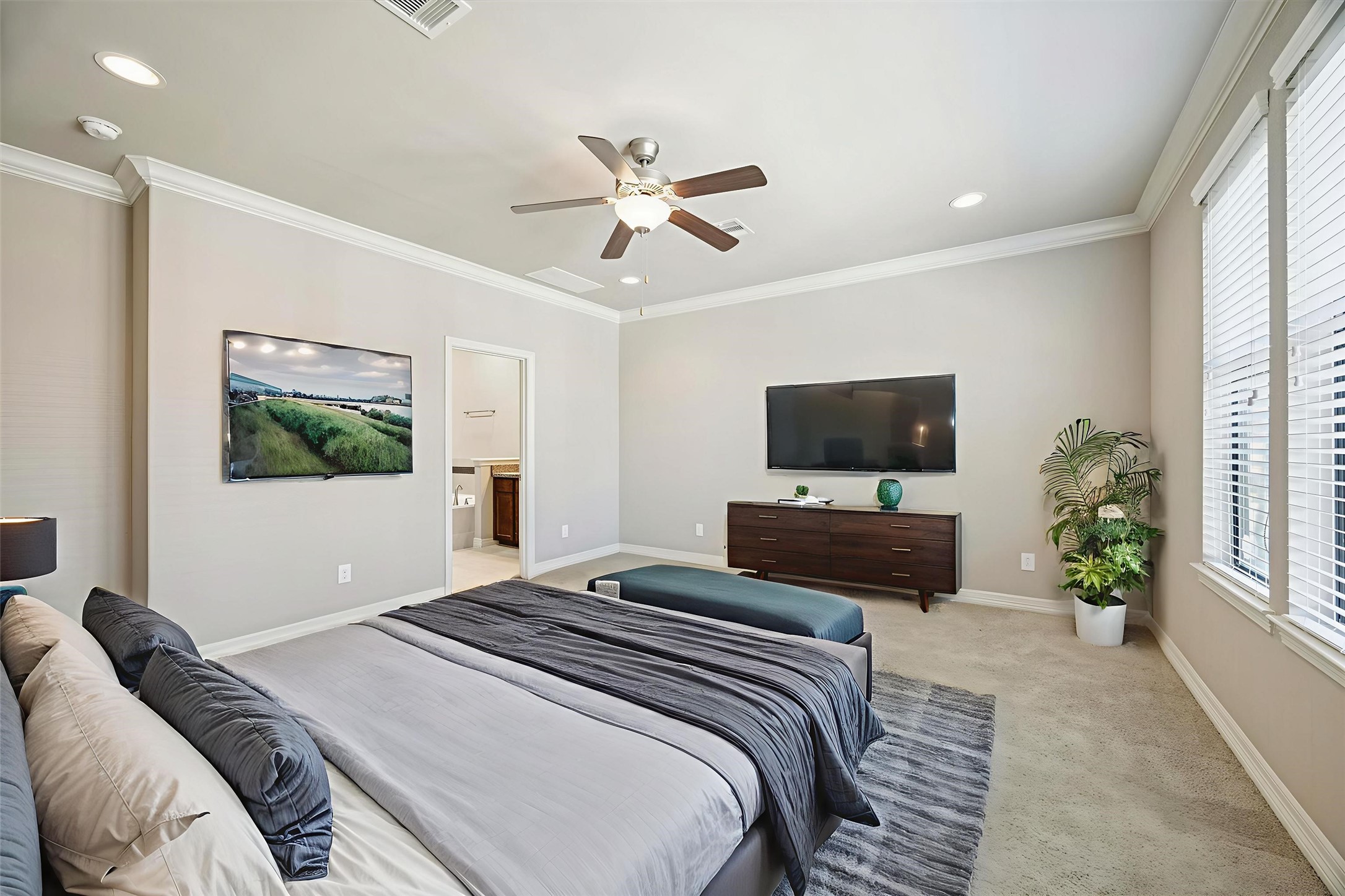5749 Larkin Street Houston, TX 77007 - Photo 11 of 35 The primary bedroom is 17'x16', with crown molding, recessed lighting, a triple window, and a sizeable en suite bathroom with a walk in closet, it's the perfect place to call home.