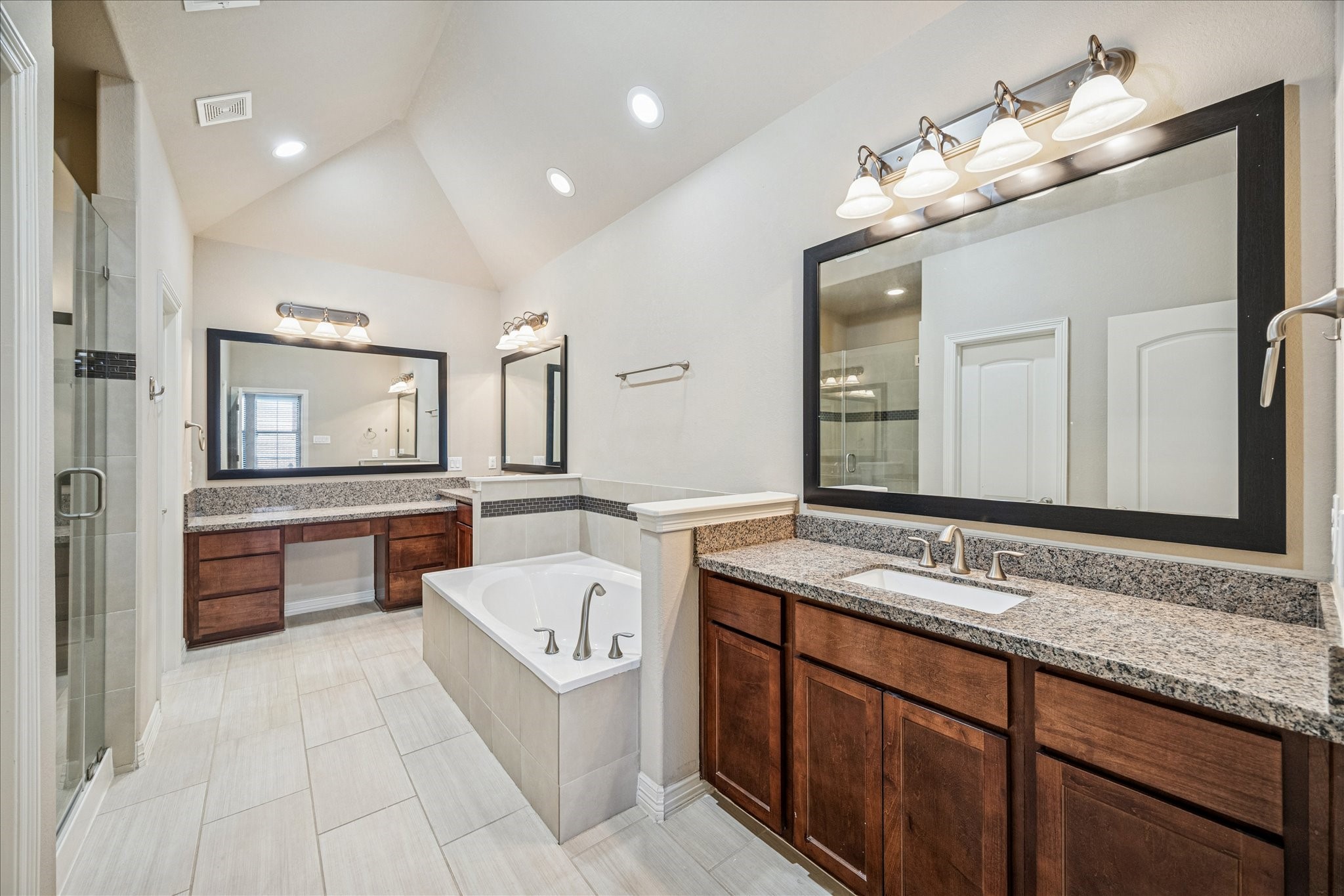5749 Larkin Street Houston, TX 77007 - Photo 12 of 35 The primary bathroom is en suite the primary bedroom and as you can see it has double sinks, a soaking tub, separate shower, and vanity space.