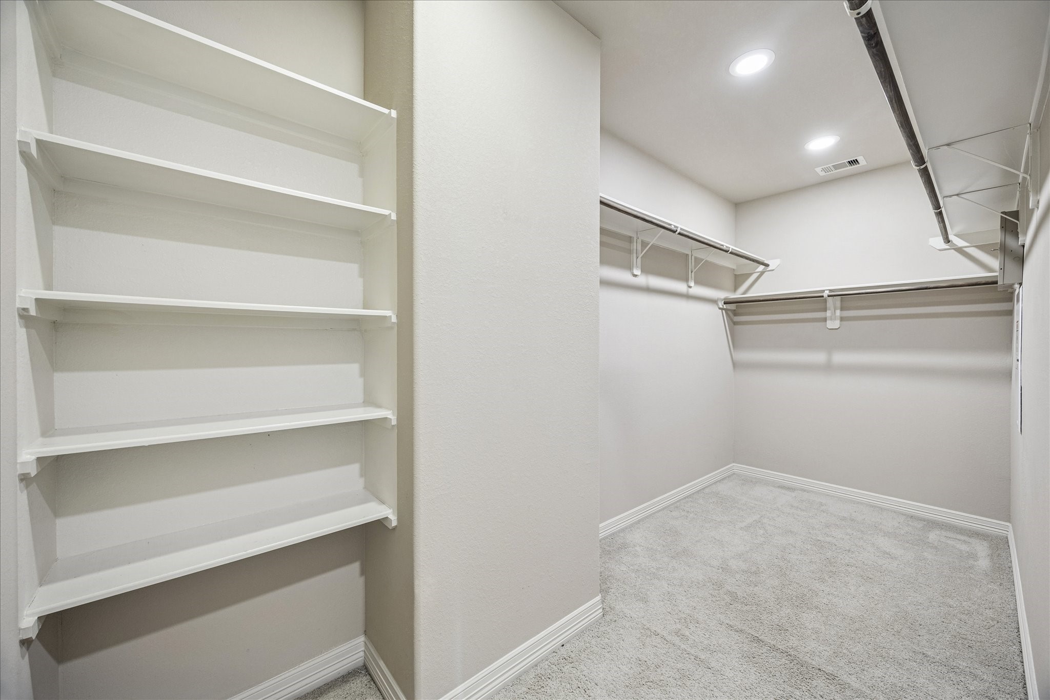 5749 Larkin Street Houston, TX 77007 - Photo 13 of 35 This is just a portion of the primary closet. It is accessible through the primary bathroom. It's built in shelves and rods make it convenient to organize your things neatly.