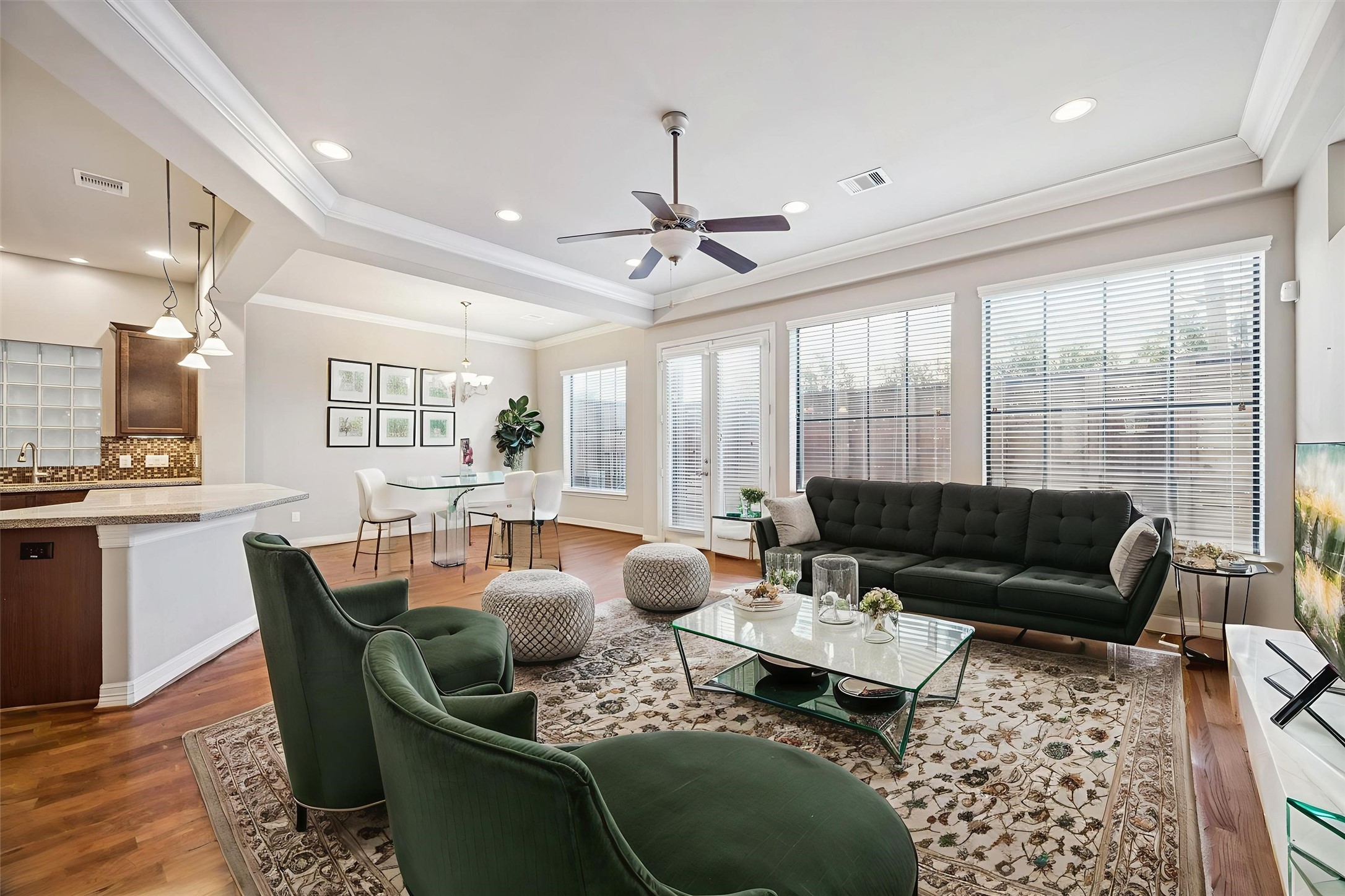 5749 Larkin Street Houston, TX 77007 - Photo 6 of 35 This common area is on the first floor and has a foyer with an en suite powder bathroom and is connected to access to the garage. The backyard space is fully fenced in and accessible through the double French doors pictured.