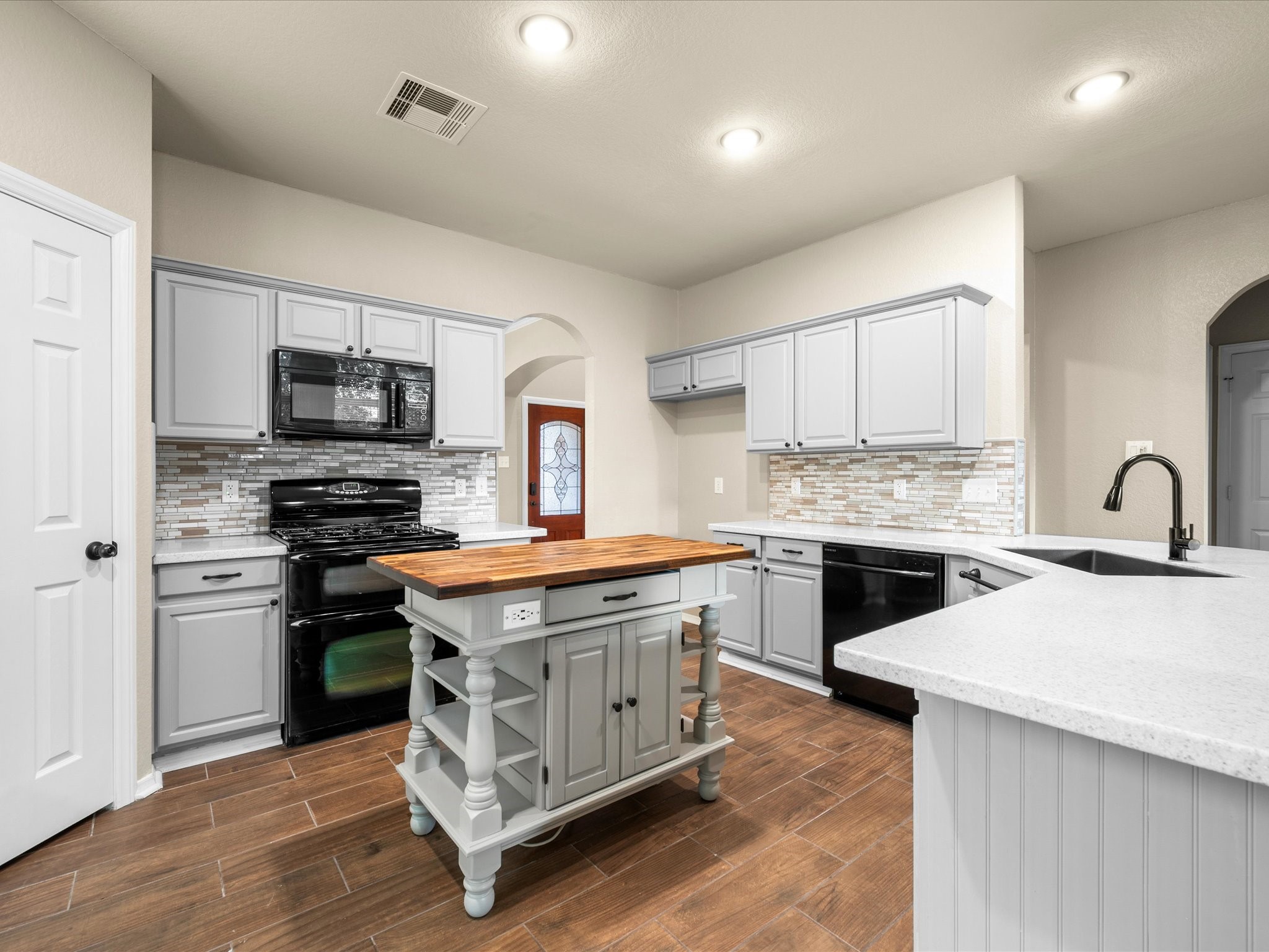 291 Sunset Path South Conroe, TX 77316 - Photo 12 of 39 The center island includes convenient power access, while abundant cabinetry, new countertops & a spacious pantry provide excellent storage and workspace.