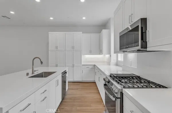 a kitchen that has a sink and a stove