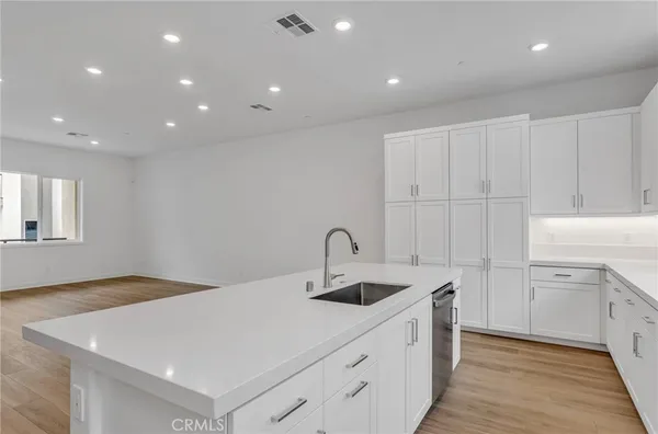 a kitchen that has a sink and a stove in it