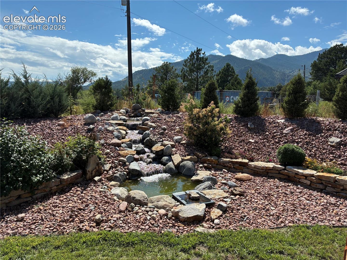 8480 Delaware Road Colorado Springs, CO 80926 - Photo 47 of 50 Summer 2025 view of the water feature