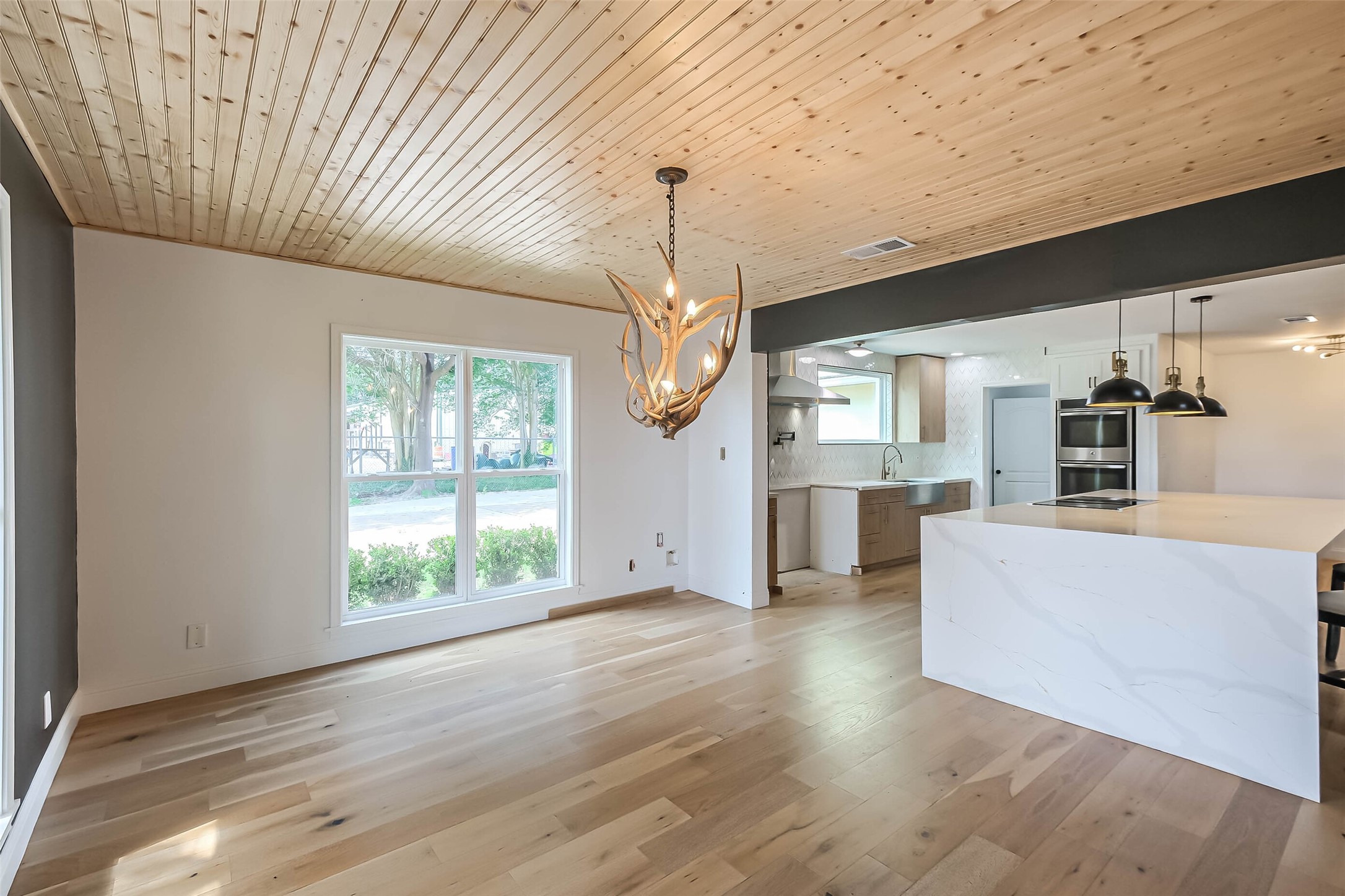 11019 Clodine Road Sugar Land, TX 77498 - Photo 11 of 39 a view of a kitchen with furniture and wooden floor