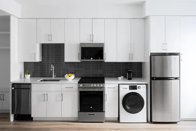 a kitchen with a sink a stove and cabinets
