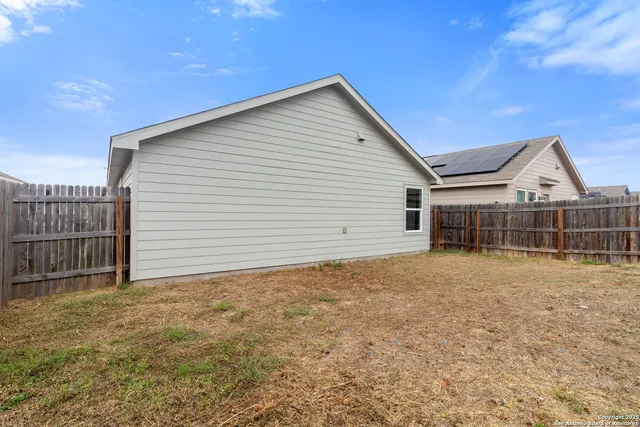 a view of a house with a backyard