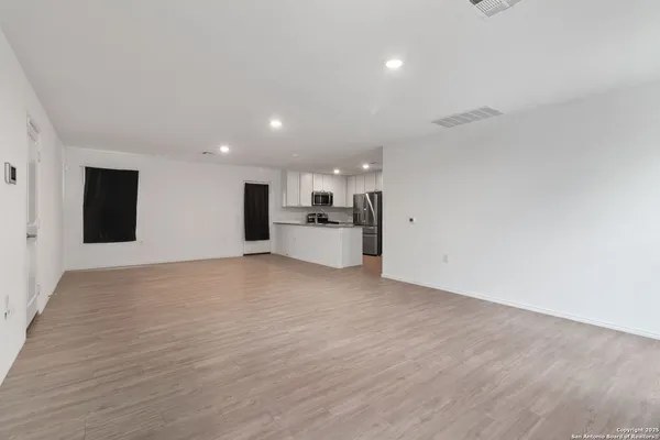 a view of a kitchen with a sink and a refrigerator