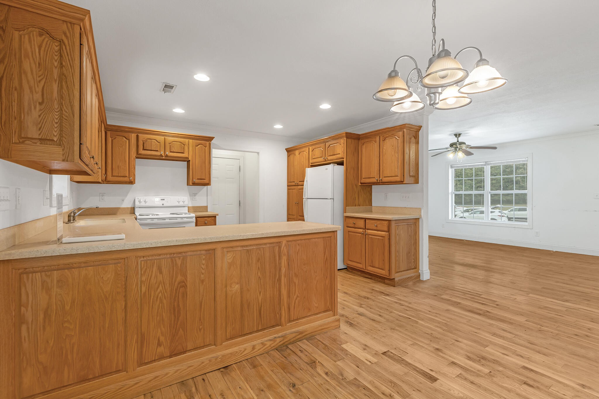 173 Hidden Meadow Lane Dunlap, TN 37327 - Photo 8 of 22 a kitchen with stainless steel appliances granite countertop a sink a stove a refrigerator cabinets and wooden floor