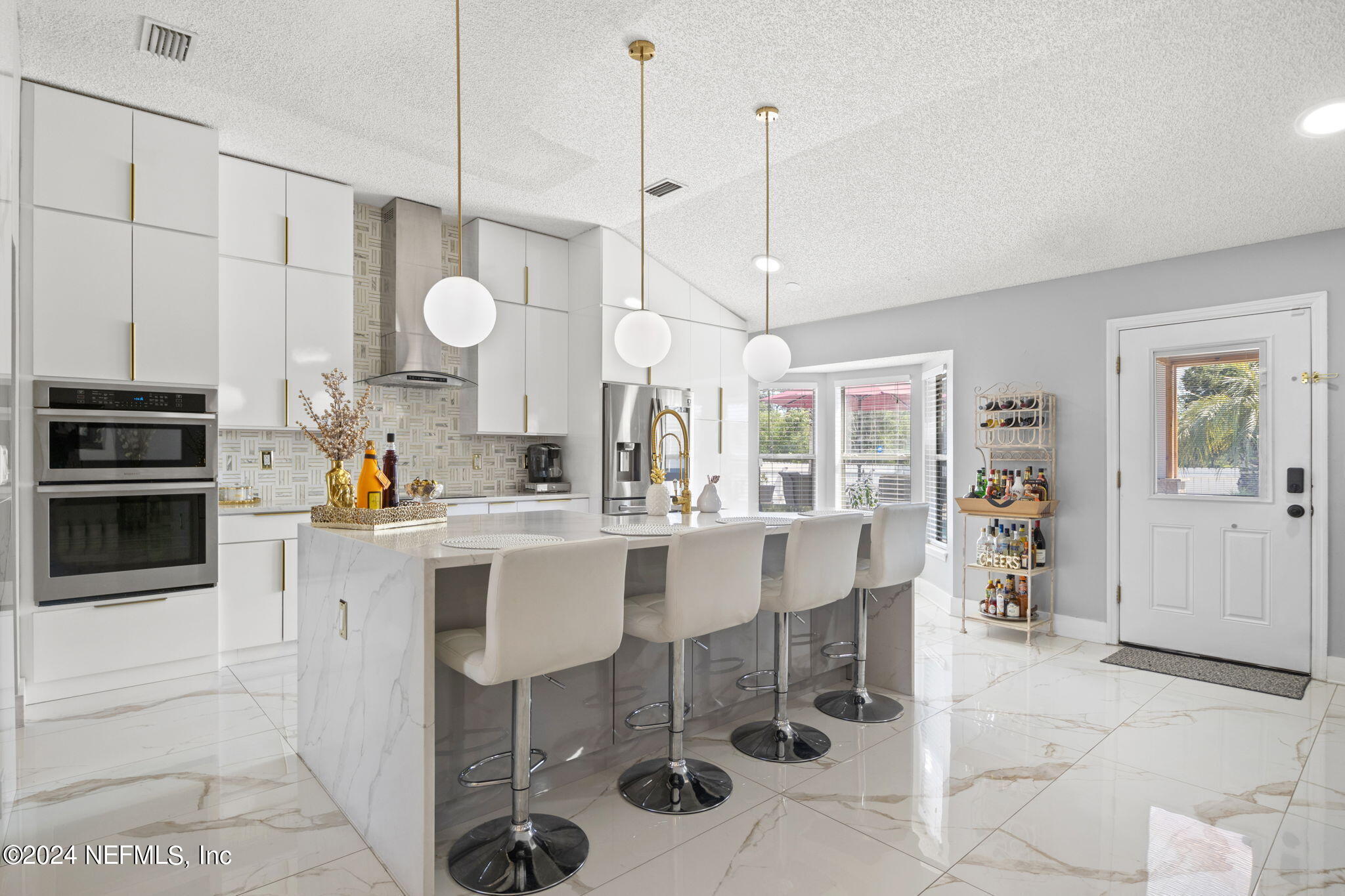 487 Portobello Drive Jacksonville, FL 32221 - Photo 3 of 9 a kitchen with stainless steel appliances kitchen island granite countertop a stove a sink and a refrigerator