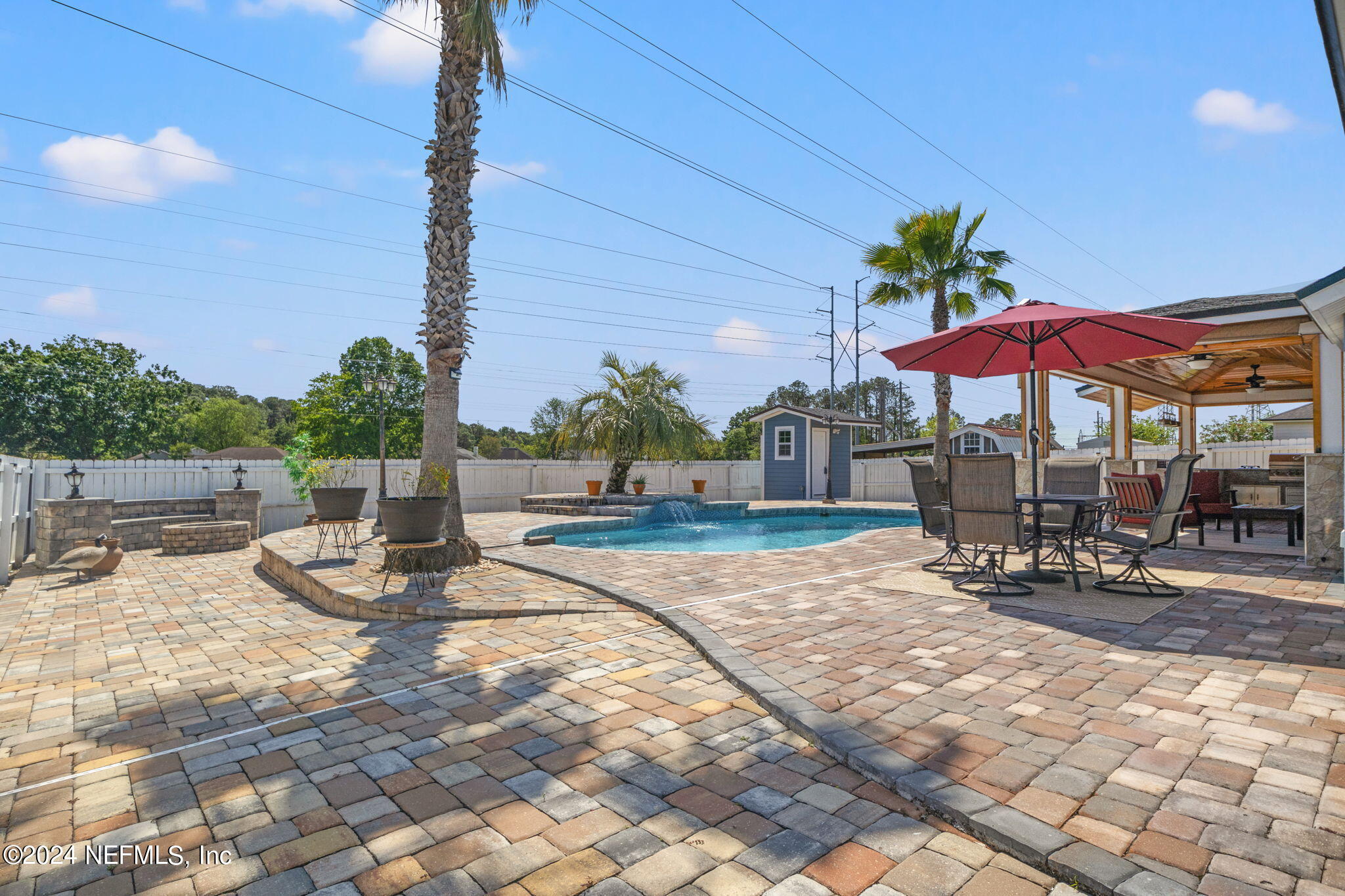 487 Portobello Drive Jacksonville, FL 32221 - Photo 9 of 9 a view of a patio with a table and chairs under an umbrella