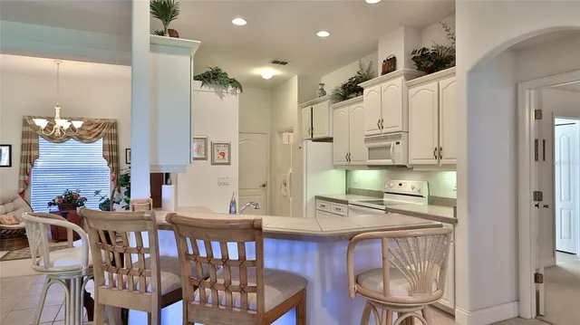 a view of a chairs and table in patio with a lake view