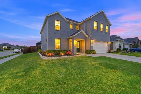 a front view of a house with a yard