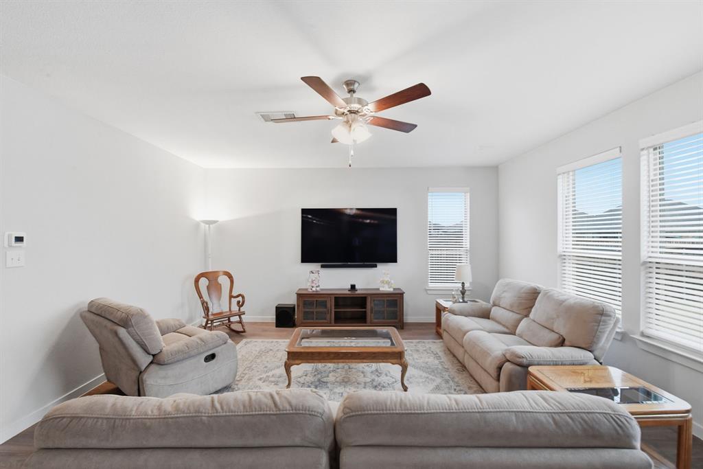 4228 Bullock Lane Forney, TX 75126 - Photo 13 of 40 a living room with furniture and a flat screen tv