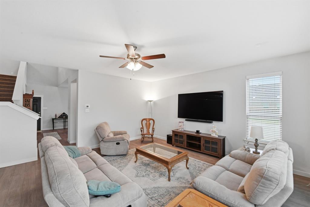 4228 Bullock Lane Forney, TX 75126 - Photo 15 of 40 a living room with furniture a flat screen tv and a window