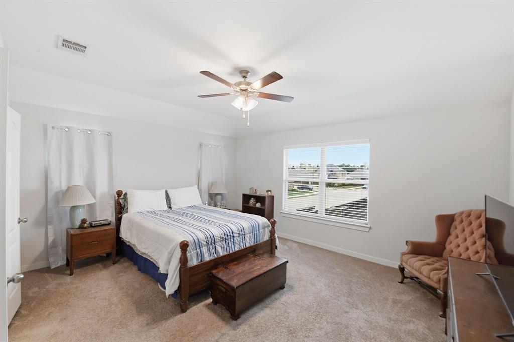 4228 Bullock Lane Forney, TX 75126 - Photo 24 of 40 a bedroom with a bed and window