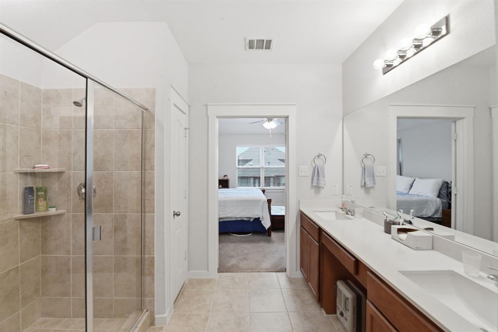 4228 Bullock Lane Forney, TX 75126 - Photo 26 of 40 a bathroom with a double vanity sink mirror and shower