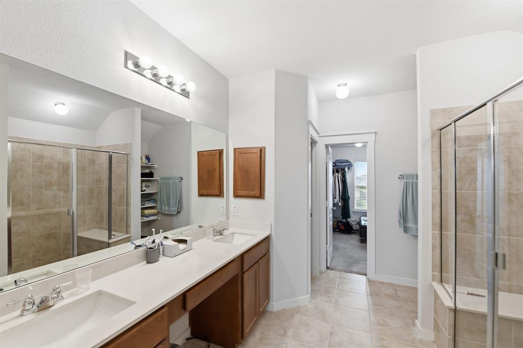 4228 Bullock Lane Forney, TX 75126 - Photo 27 of 40 a bathroom with a double vanity sink mirror and shower