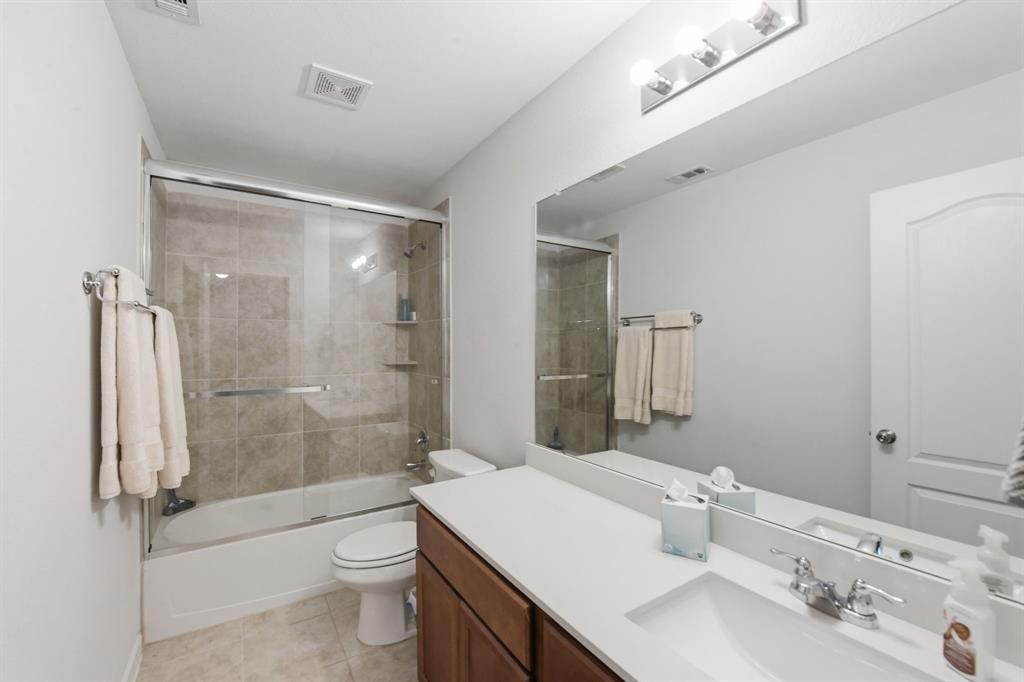 4228 Bullock Lane Forney, TX 75126 - Photo 29 of 40 a bathroom with a sink a toilet and shower