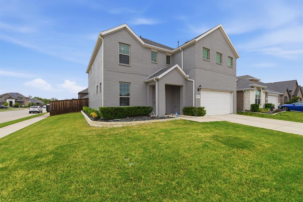 4228 Bullock Lane Forney, TX 75126 - Photo 3 of 40 a front view of a house with a yard and garage