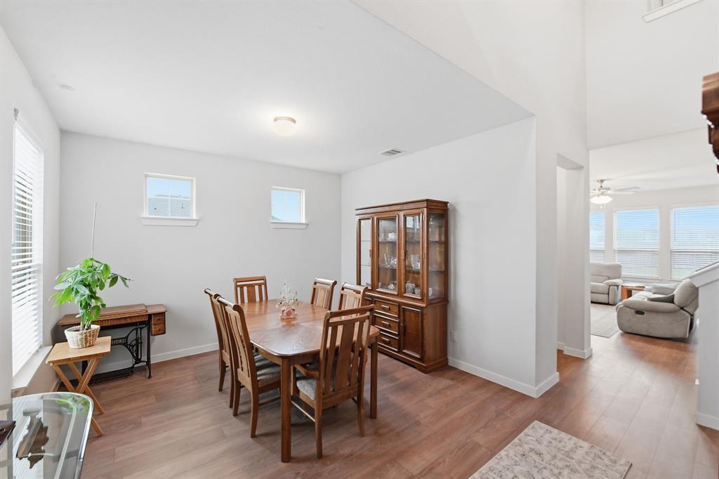 4228 Bullock Lane Forney, TX 75126 - Photo 5 of 40 a view of a dining room with furniture and wooden floor