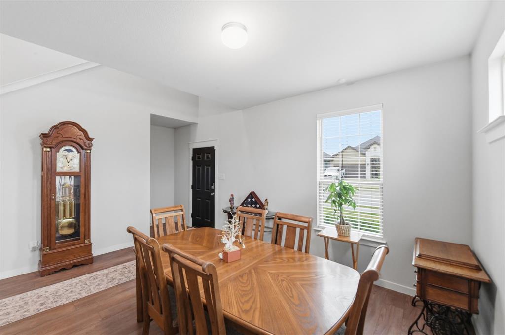 4228 Bullock Lane Forney, TX 75126 - Photo 7 of 40 a view of a dining room with furniture window and wooden floor