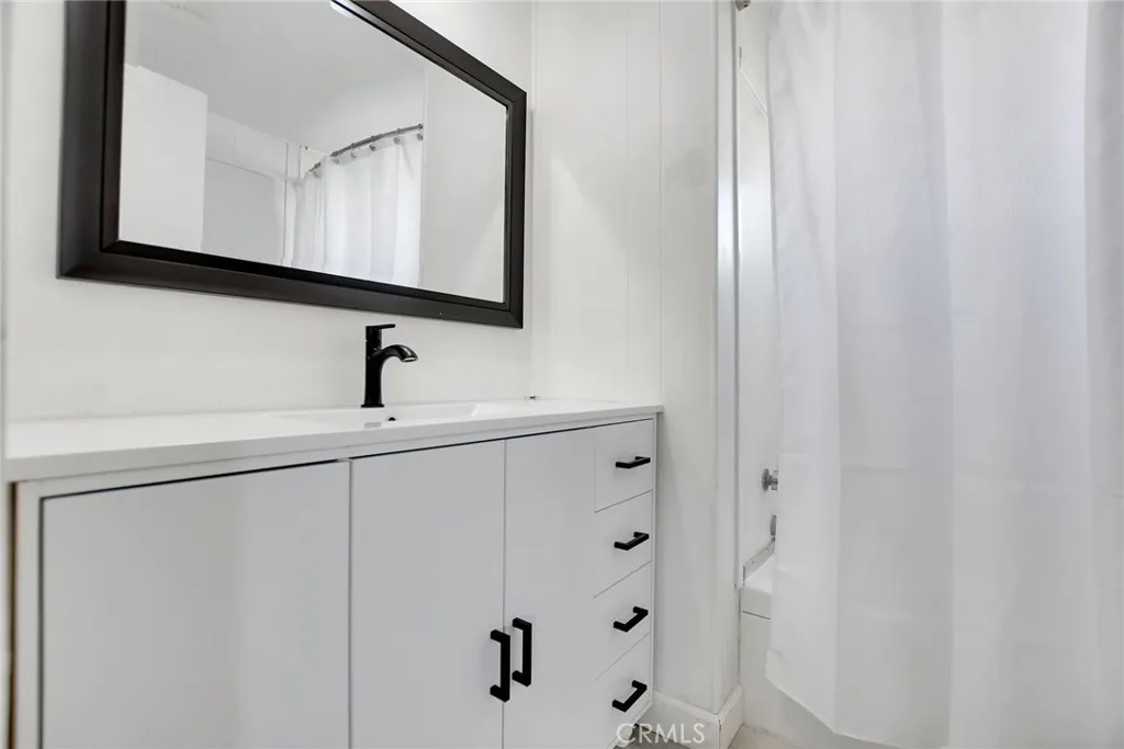 840 Foothill, Unit 27 Azusa, CA 91702 - Photo 22 of 30 a bathroom with a sink and a mirror