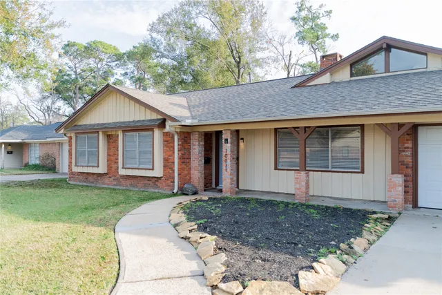 a front view of a house with a yard and porch