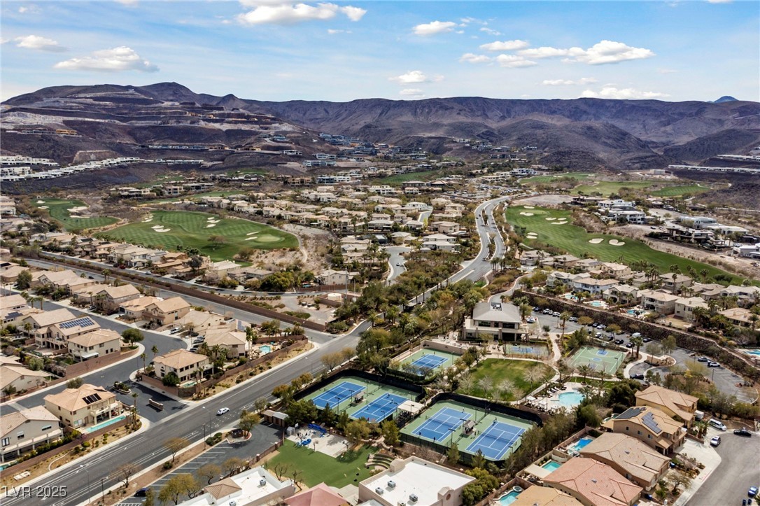 471 Cityview Ridge Drive Henderson, NV 89012 - Photo 24 of 28 Aerial view of property and surrounding area with a local golf course, a mountainous background, and nearby suburban area