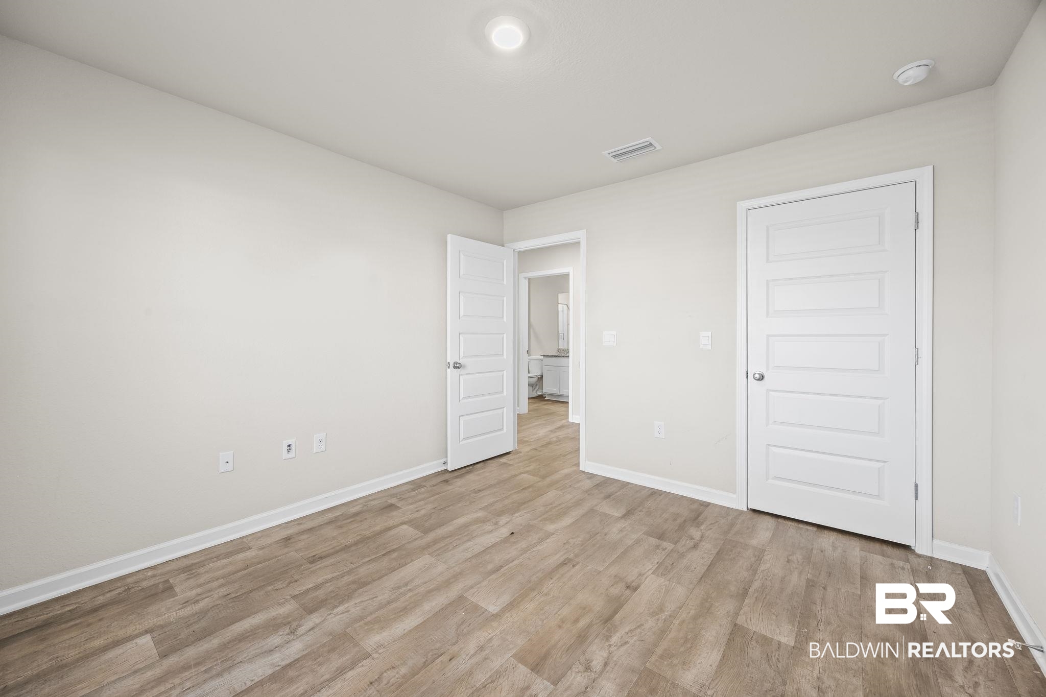3090 Camino Real Loop Lillian, AL 36549 - Photo 20 of 29 Unfurnished bedroom with baseboards and light wood-type flooring