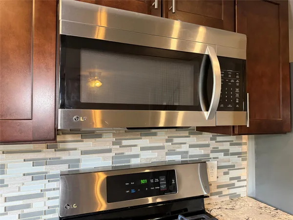 a stove top oven sitting inside of a kitchen
