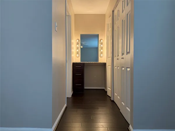 a view of a hallway with wooden floor