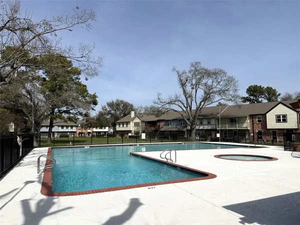 a view of a swimming pool with a house