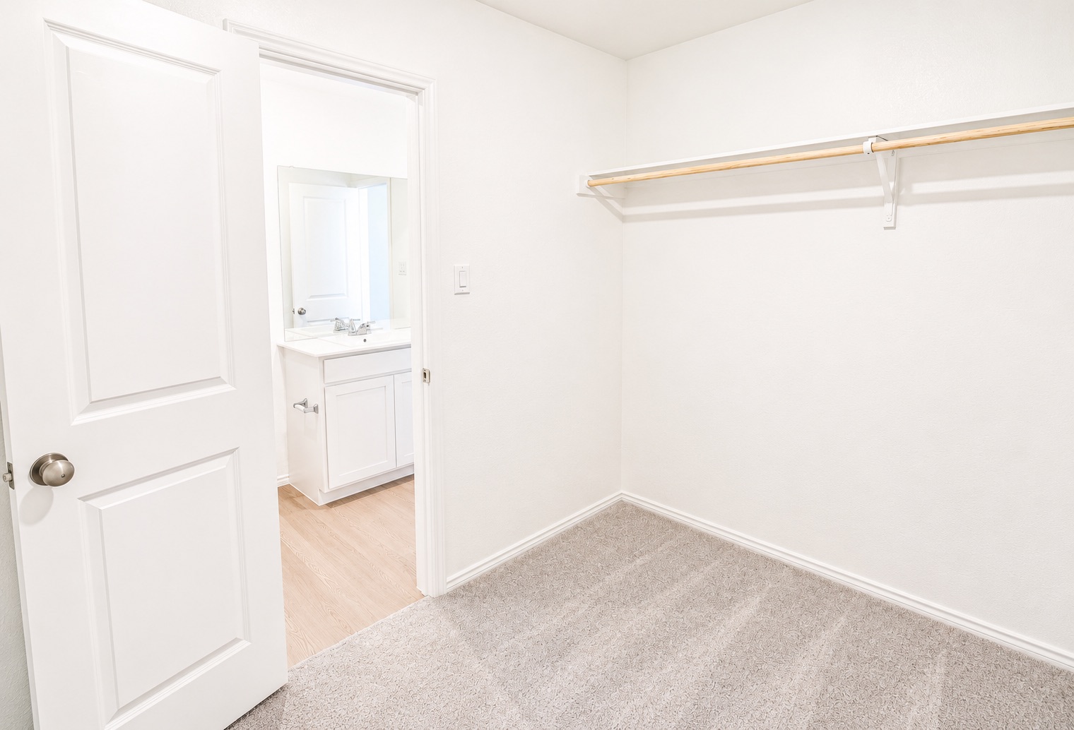 397 Keefer Kyle, TX 78640 - Photo 15 of 33 A well-organized closet space offers ample storage, adjoining a sleek, modern bathroom.