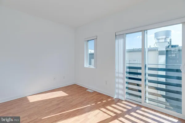 a view of wooden floor and windows in a room