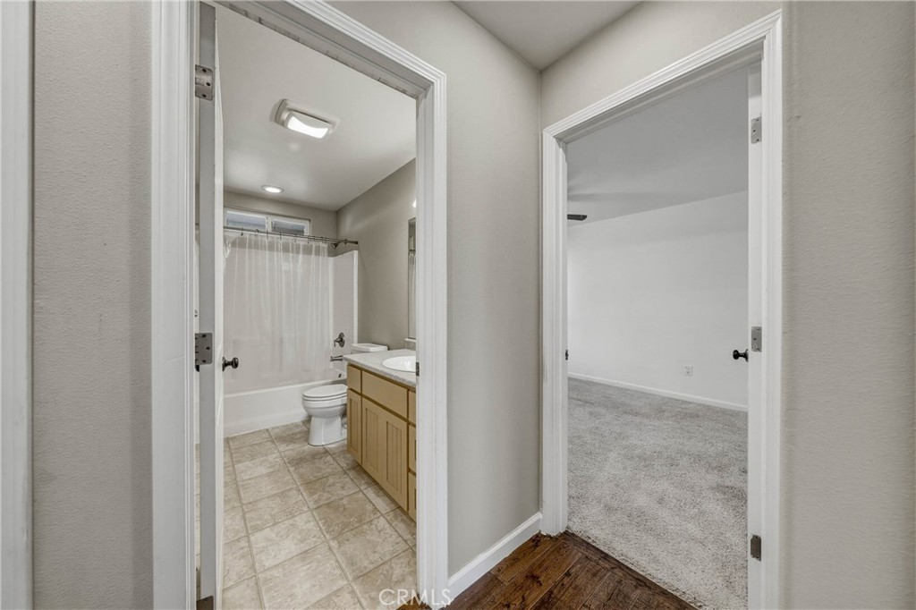 3483 Beach Street Nice, CA 95464 - Photo 19 of 40 a bathroom with a granite countertop sink mirror and toilet