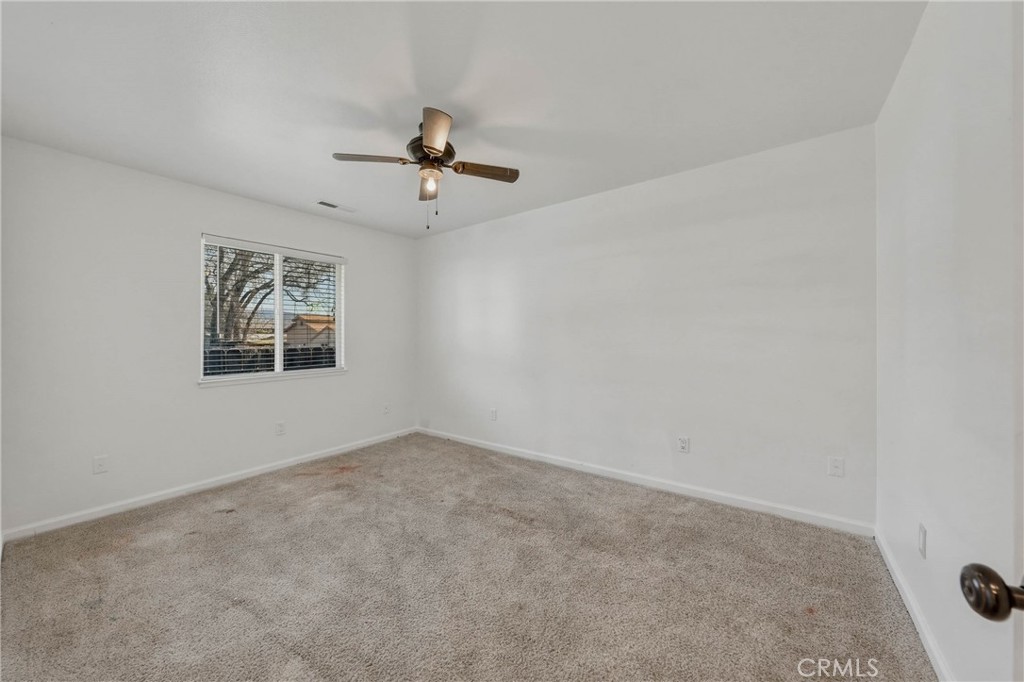 3483 Beach Street Nice, CA 95464 - Photo 21 of 40 an empty room with windows and fan