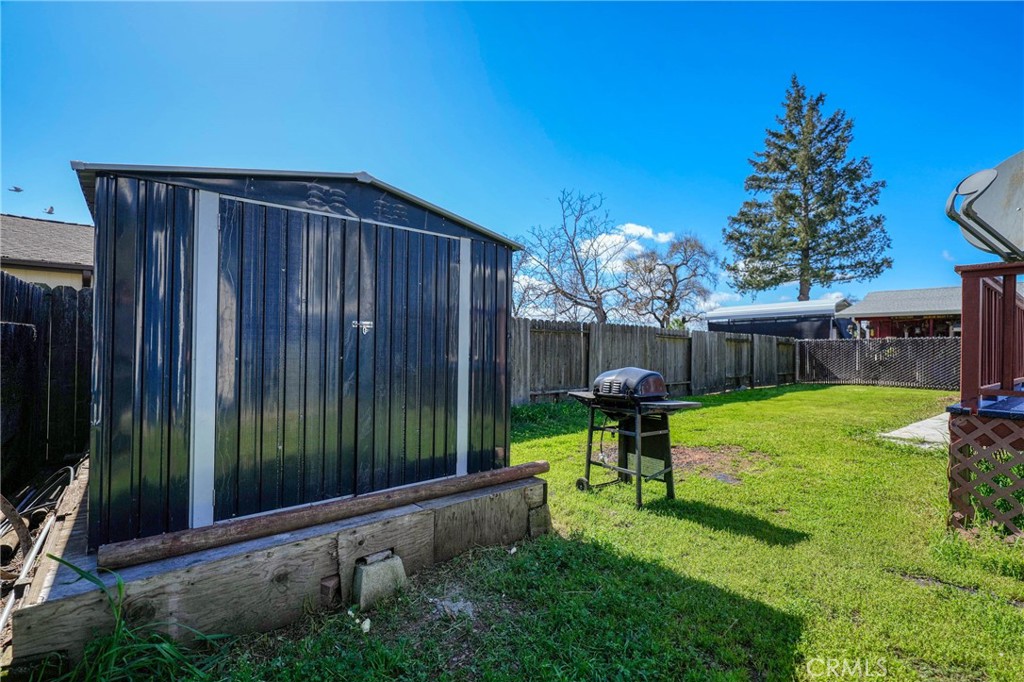 3483 Beach Street Nice, CA 95464 - Photo 36 of 40 a view of a backyard with table and chairs potted plants and wooden fence