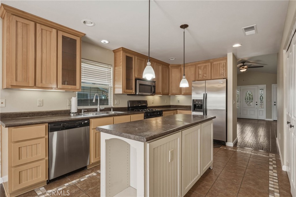3483 Beach Street Nice, CA 95464 - Photo 8 of 40 a kitchen with stainless steel appliances granite countertop a sink a stove a refrigerator and island with wooden floor