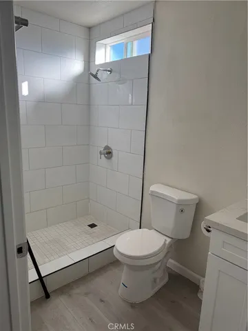 a bathroom with a toilet and a shower