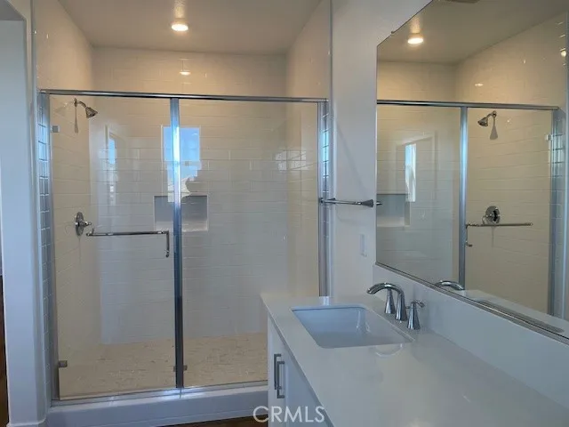 a bathroom with a shower and a sink