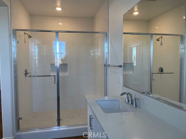 213 Shoveler Irvine, CA 92618 - Photo 14 of 19 a bathroom with a shower and a sink