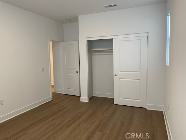 213 Shoveler Irvine, CA 92618 - Photo 17 of 19 an empty room with wooden floor and closet