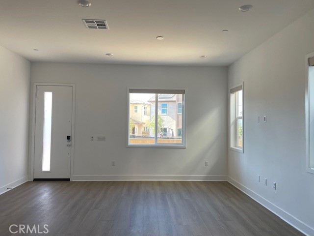 213 Shoveler Irvine, CA 92618 - Photo 3 of 19 an empty room with wooden floor and windows