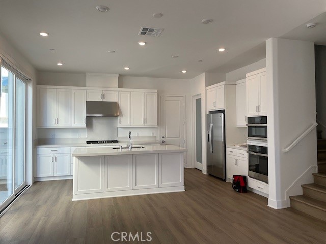 213 Shoveler Irvine, CA 92618 - Photo 4 of 19 a kitchen with stainless steel appliances a stove and refrigerator
